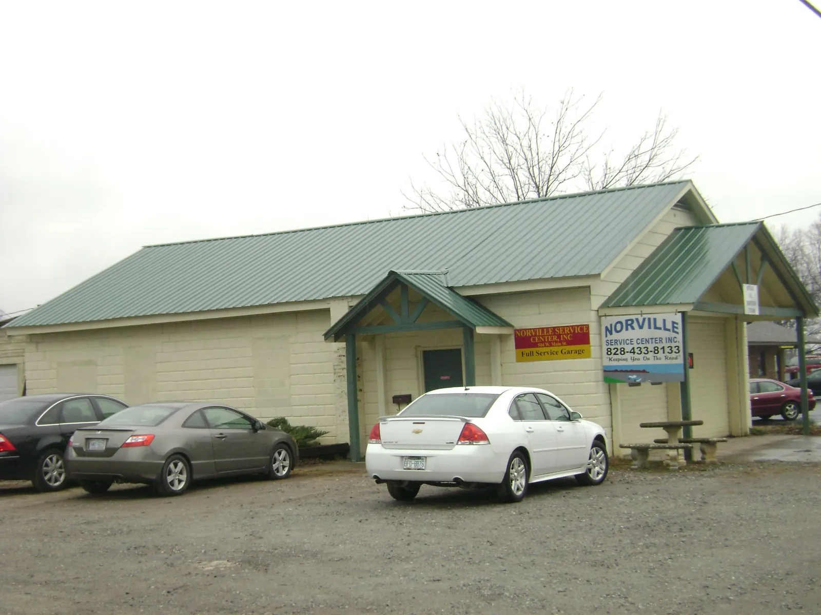 Green metal roof on a service garage with a covered entry in Lake City